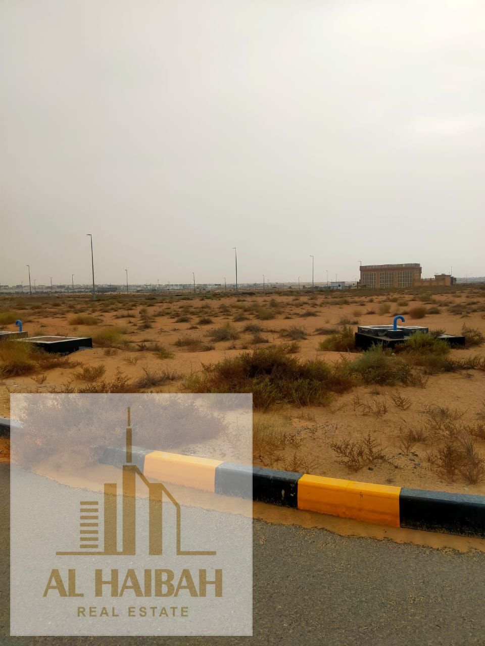 Commercial land for sale in the Muwailih Commercial Area – Al-Falah Camp, in a prime location near Al-Zahia Villas, within a vibrant area experiencing