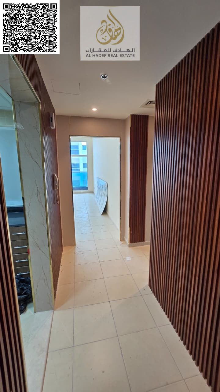 The most beautiful two-bedroom apartment in Ajman One | Two bedrooms, a living room, three bathrooms, built-in wardrobes, a balcony, a laundry room, a