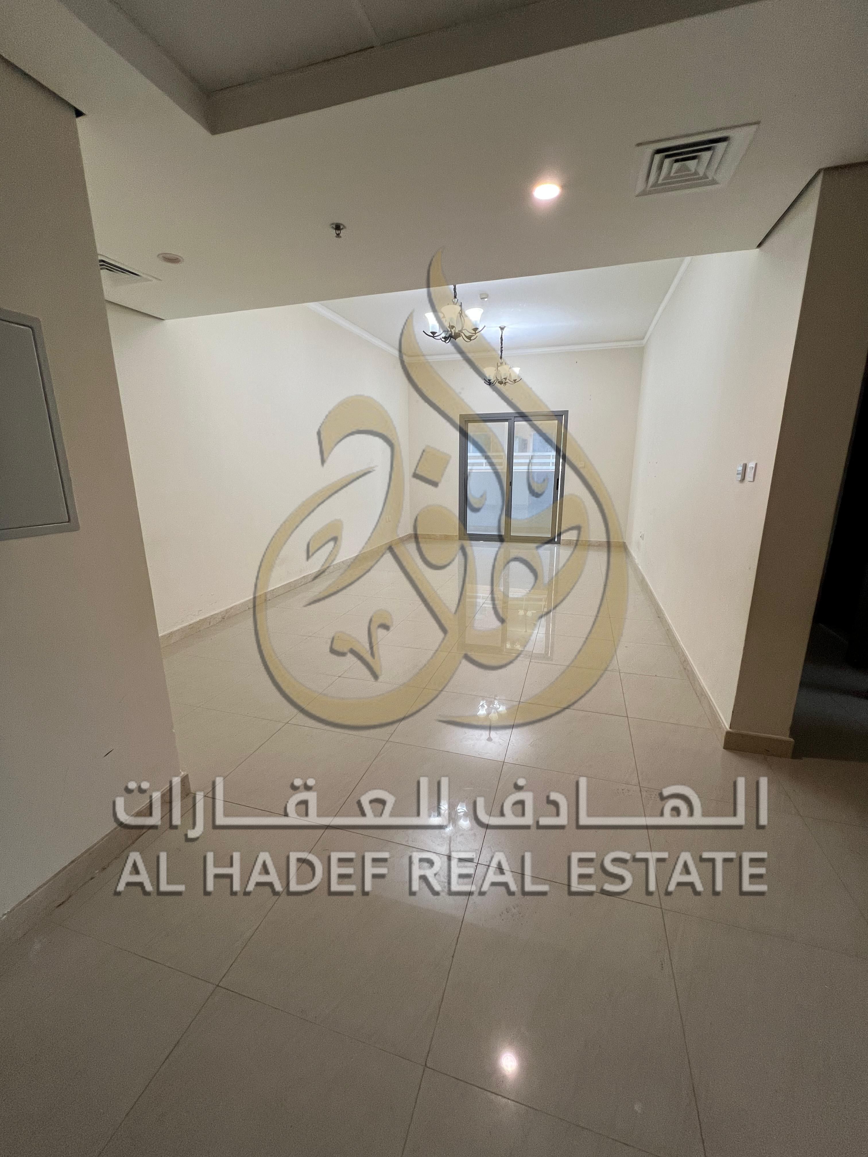 In Al Nahda area, a two-bedroom apartment is available, featuring a master bedroom with a balcony, three bathrooms, built-in wardrobes, very spacious