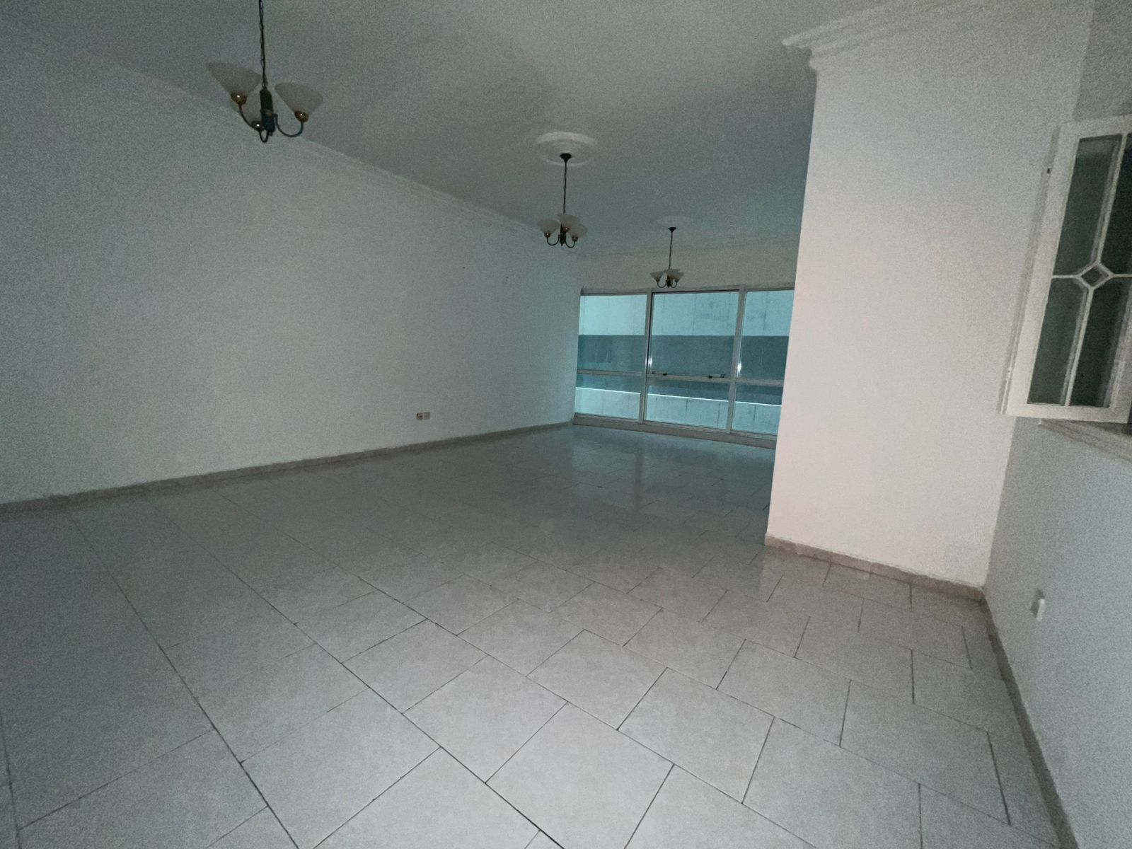 2 bedroom apartment with living room in Al Majaz 2, free AC, spacious layout, 2 bathrooms, near Dubai exit and services.