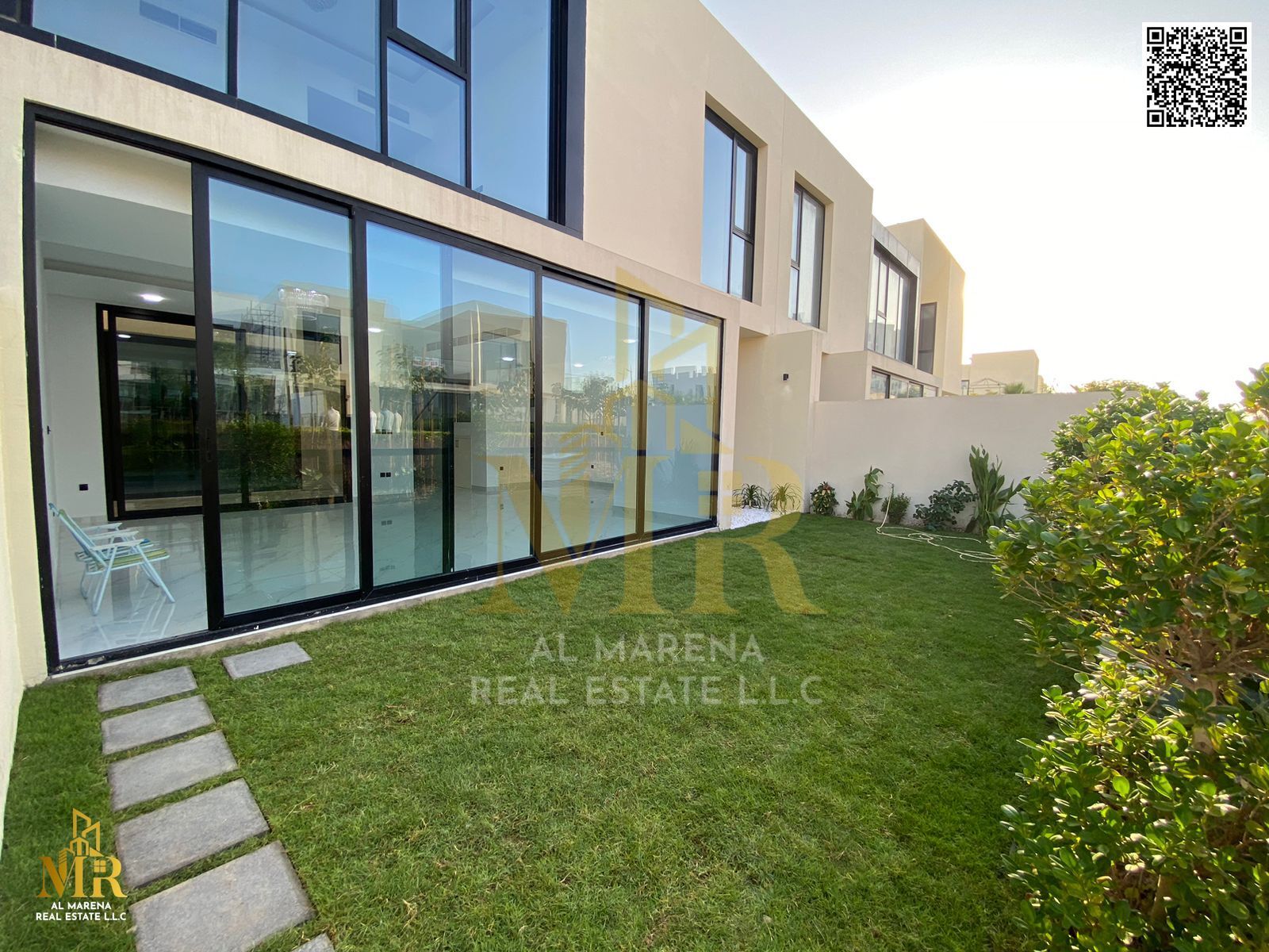 For rent in the heart of Al Zorah, a four-bedroom master villa with a garden, prime location and partial golf course view, a quiet and luxurious resid