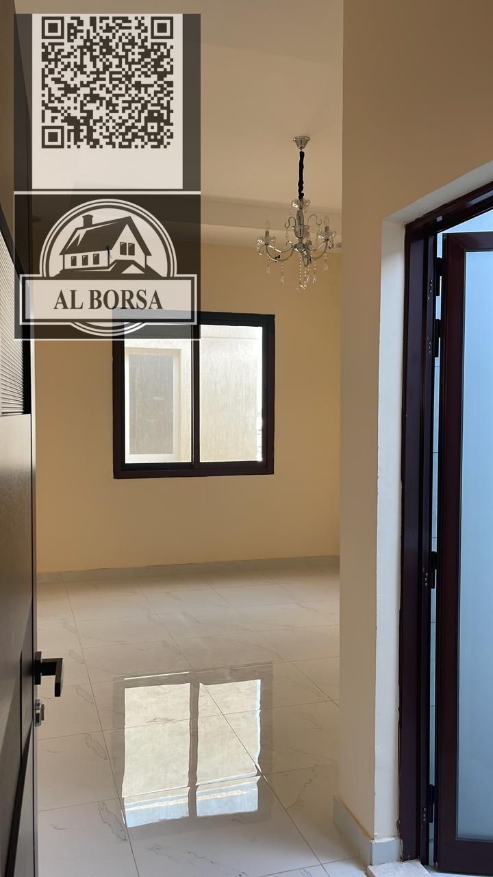 Two-story villa for rent in Al Zahia, Ajman. 5 master bedrooms, 2 living rooms, and a kitchen. 80,000 AED