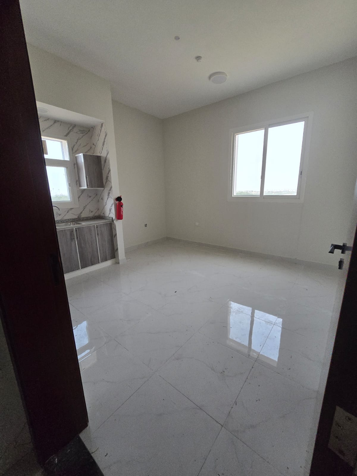 Special offer: First-time occupancy studio apartment in Al-Aliya, central air conditioning, close to Dubai and Sharjah exits.