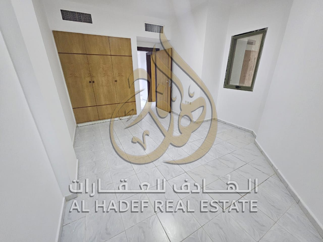 For annual rent in Sharjah - Al Majaz 2 area, a three-bedroom apartment with a living room, direct sharing, close to Al Buhairah Police Station.
