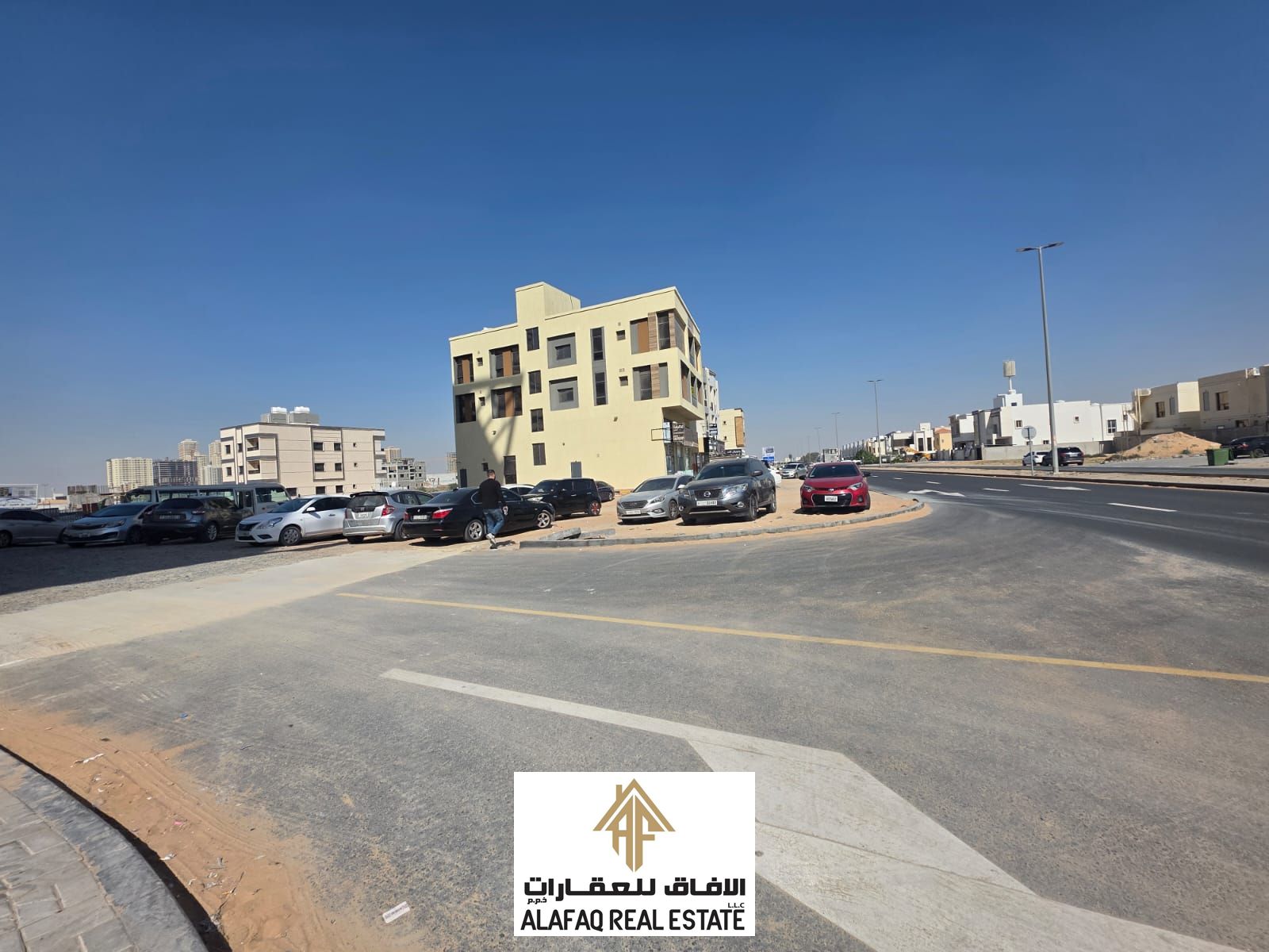 Corner residential–commercial plot on two streets in Al Amerah, second row from the main road, very close to Sheikh Mohammed Bin Zayed Road, a rare in