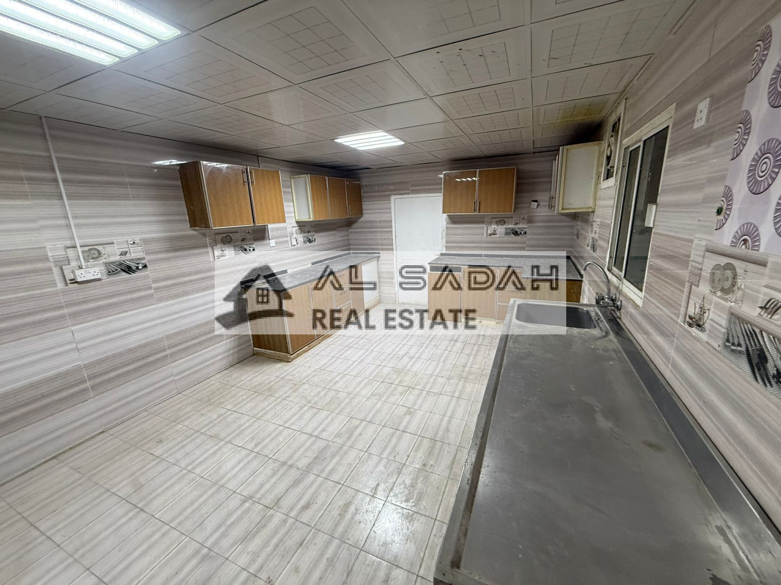 A house for rent, divided into two sections. The first section has 4 bedrooms, a living room, a majlis (formal sitting room), a kitchen, and 3 bathrooms. The second section has 2 bedrooms, a living room, a kitchen, and 2 bathrooms. Rent is 160,000 (curren