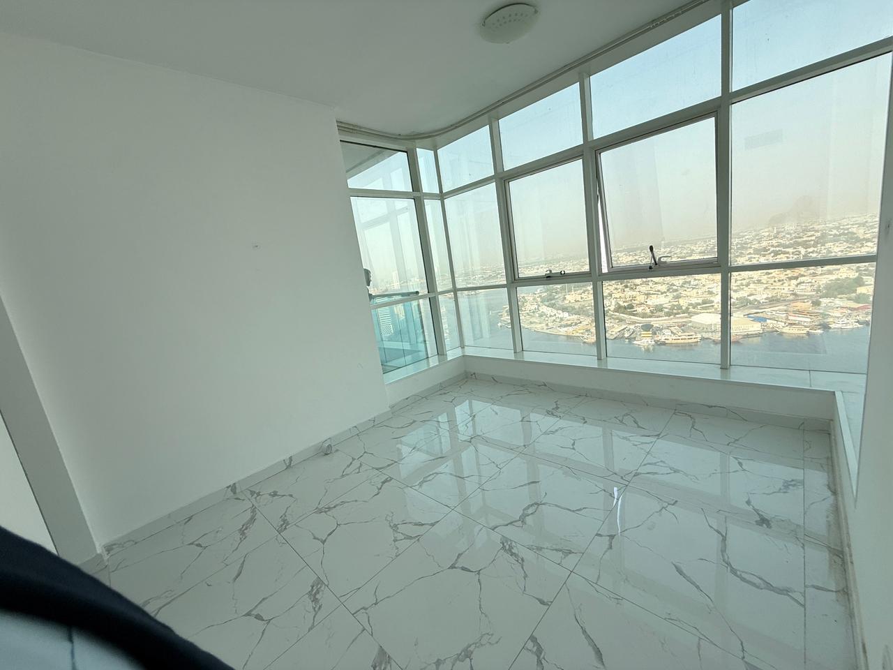 Two bedrooms and a living room with a sea view.