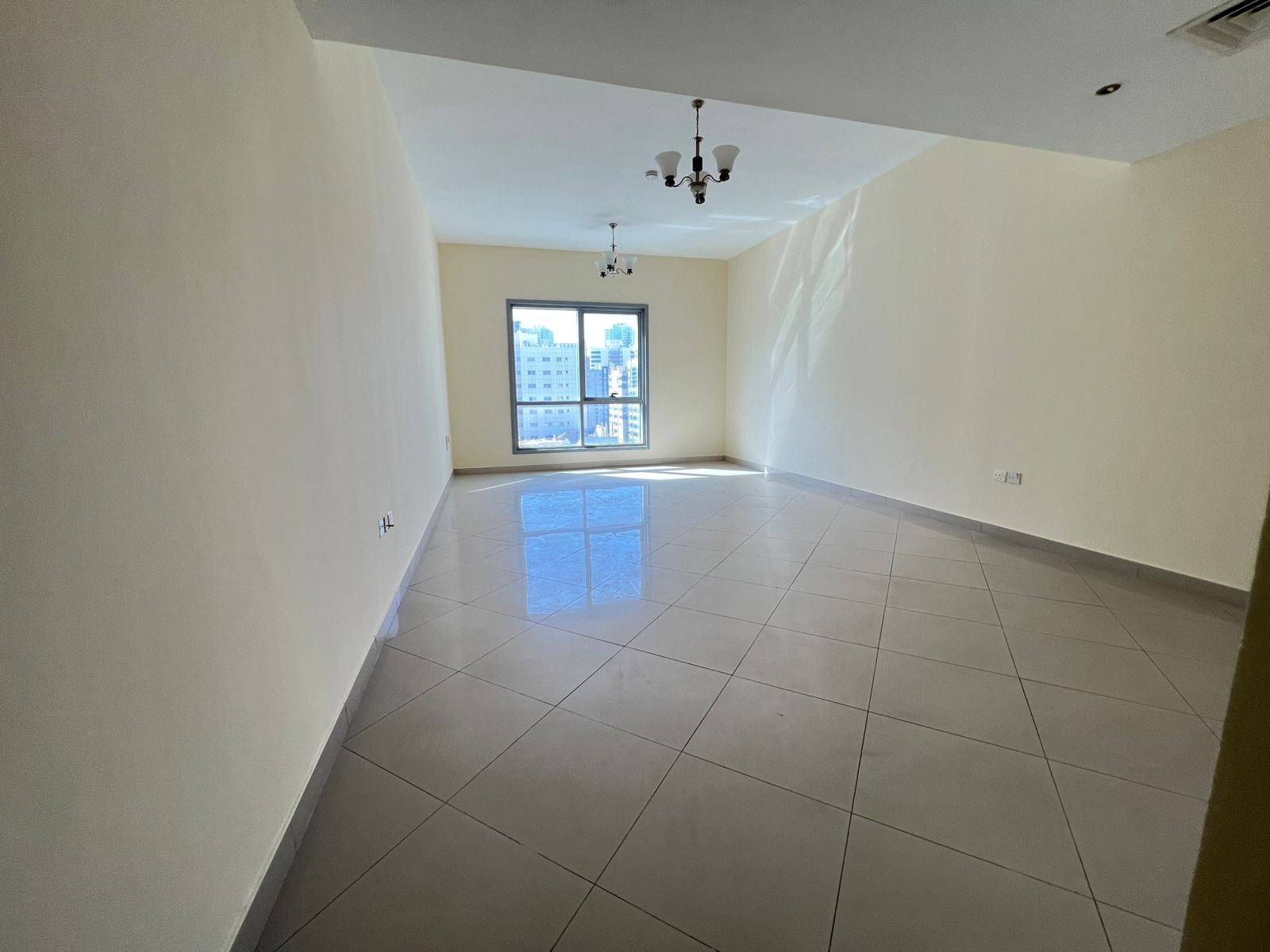 Free AC – The most beautiful and largest 2-bedroom apartment with a living room in Al Taawun, featuring a balcony and built-in wardrobes .