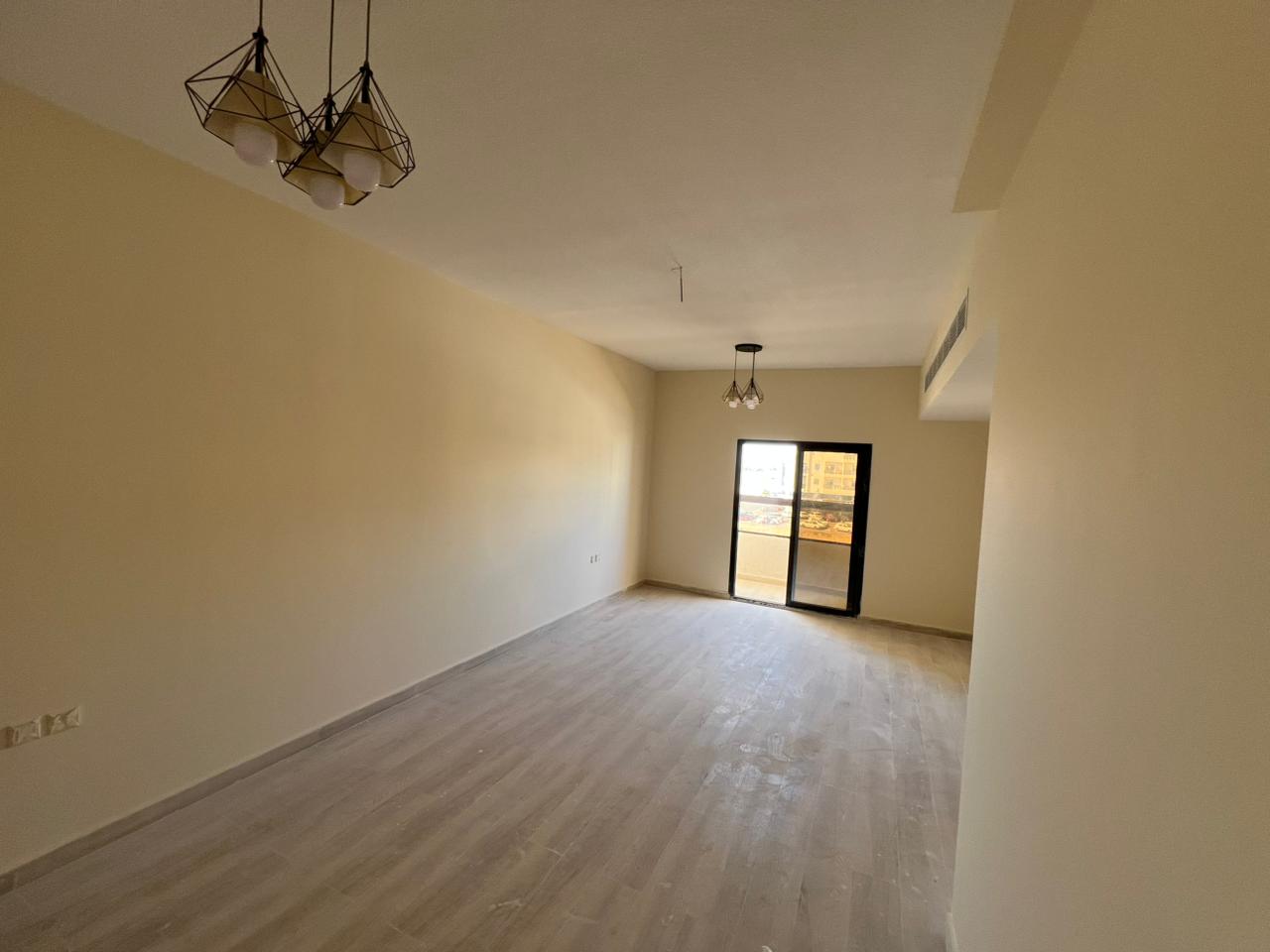 Beautiful one-bedroom apartments, first occupancy, spacious, central air conditioning, maintenance included, easy access to Dubai and Sharjah.