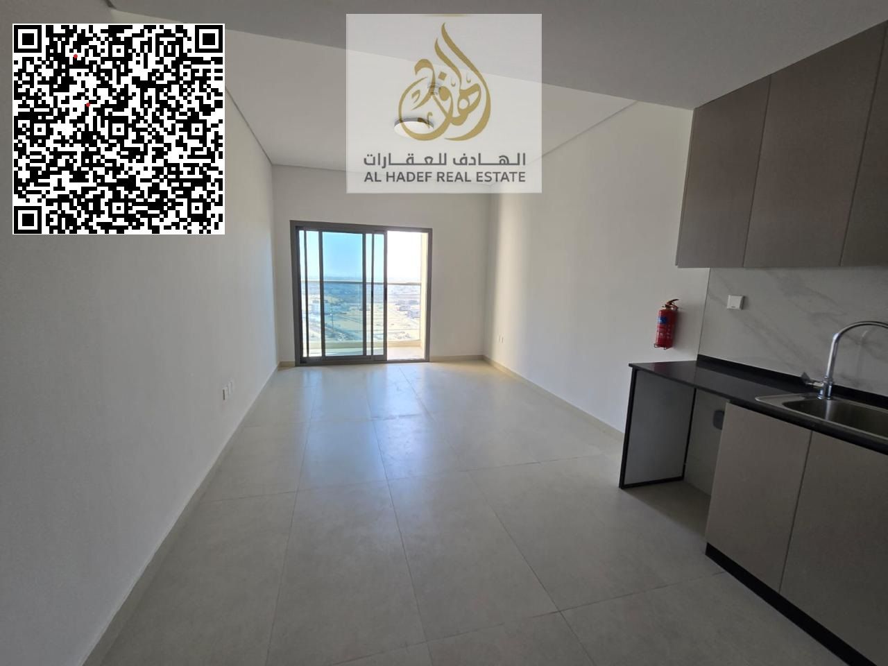 Studio apartment for annual rent with balcony and parking, very large area, Emirates Towers, directly on Mohammed Bin Zayed Road.
