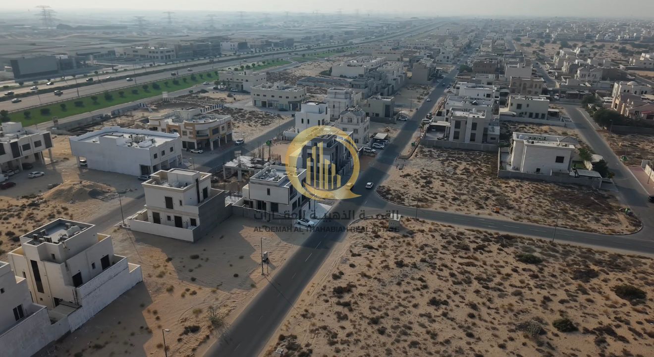 For sale: Corner commercial-front land in Sharjah, Al Houshi, Al Badiya suburb. Area: 6006 sq ft. Corner on two streets: 24 meters and 12 meters. Lice