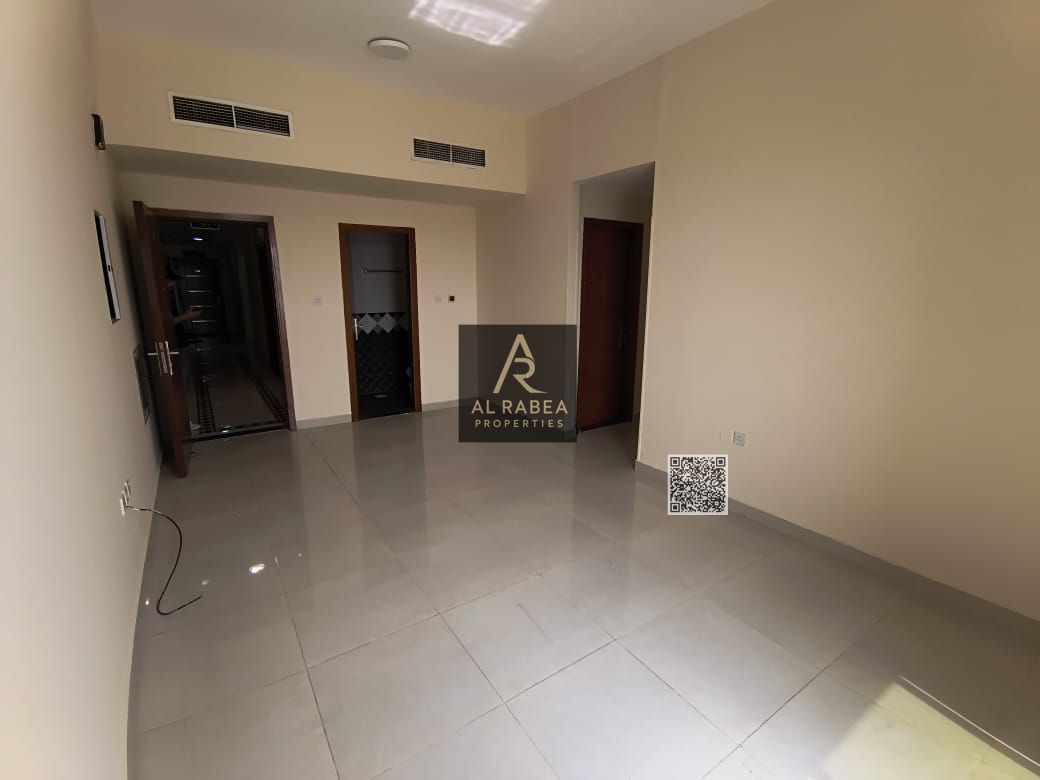 For annual rent in Ajman, Al Rawda 1 area, near Al Hamidiya Police Station: two bedrooms, a living room, three bathrooms, and a balcony. Rent is AED 4
