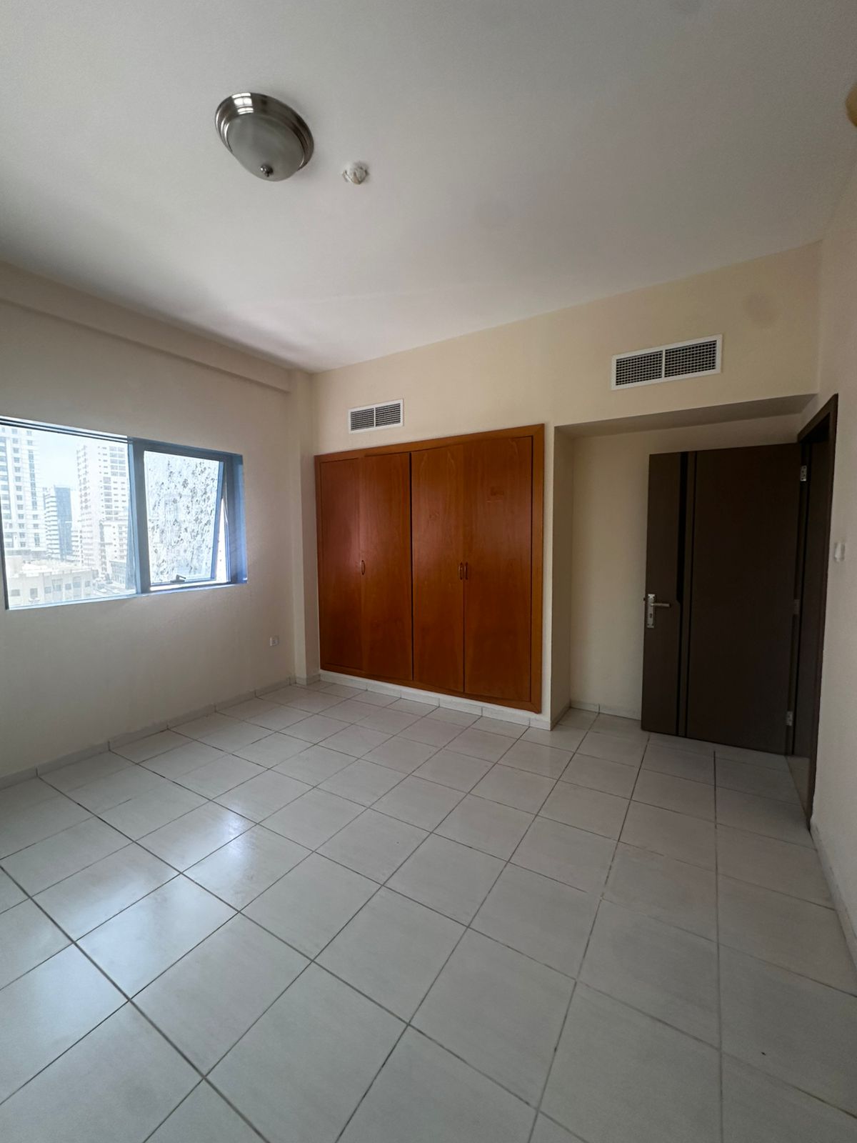 Two-bedroom apartment, second occupant, for rent in Al Rola, Sharjah – main road, balcony, central AC, built-in wardrobes