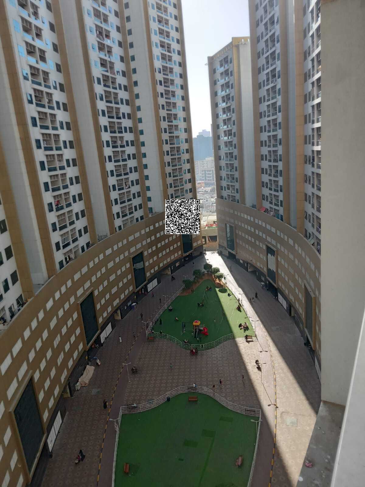 Three-bedroom apartment with a living room for sale in Pearl Towers Ajman, Al Rashidiya 1 area, behind Ramada Black Hotel, for AED 630,000 including p