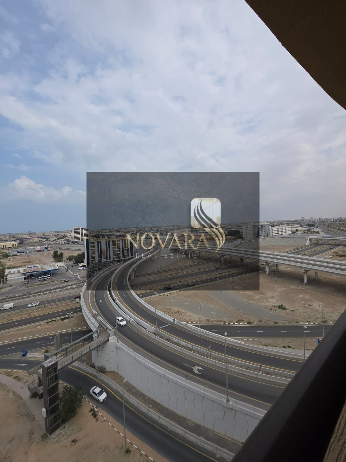 A distinctive apartment for rent in Umm Al Quwain, two bedrooms and a living room with a balcony, 1200 feet, on a main street with free parking, close