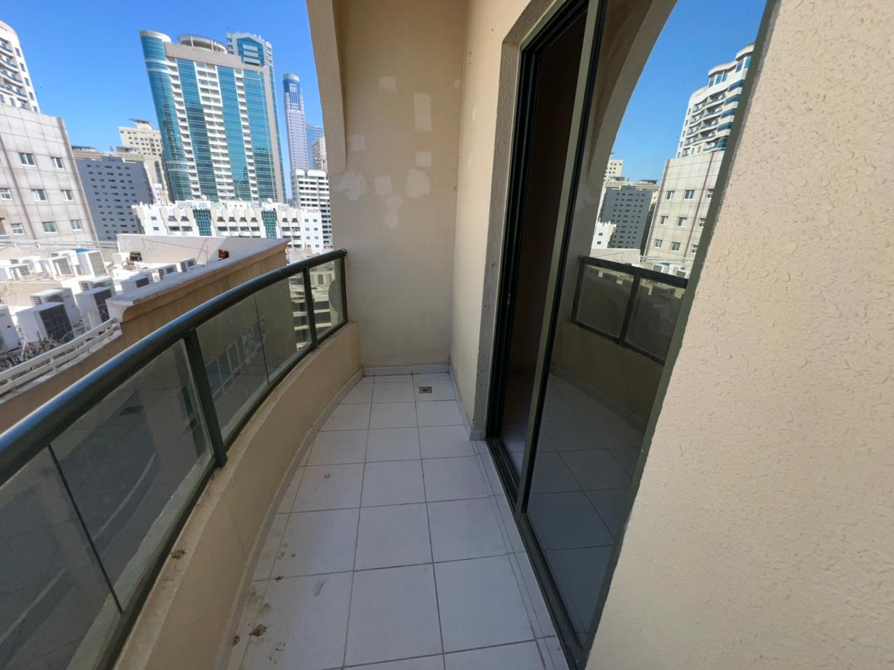 Two-bedroom apartment with balcony in Al Nahda Sharjah, open room views, gym and kids area, near Dubai exit, annual rent AED 44,000