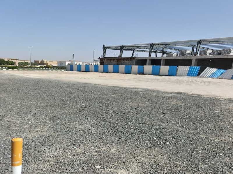 Land for sale in Industrial Area 18, measuring 12,920 square feet, prime location on the main street.