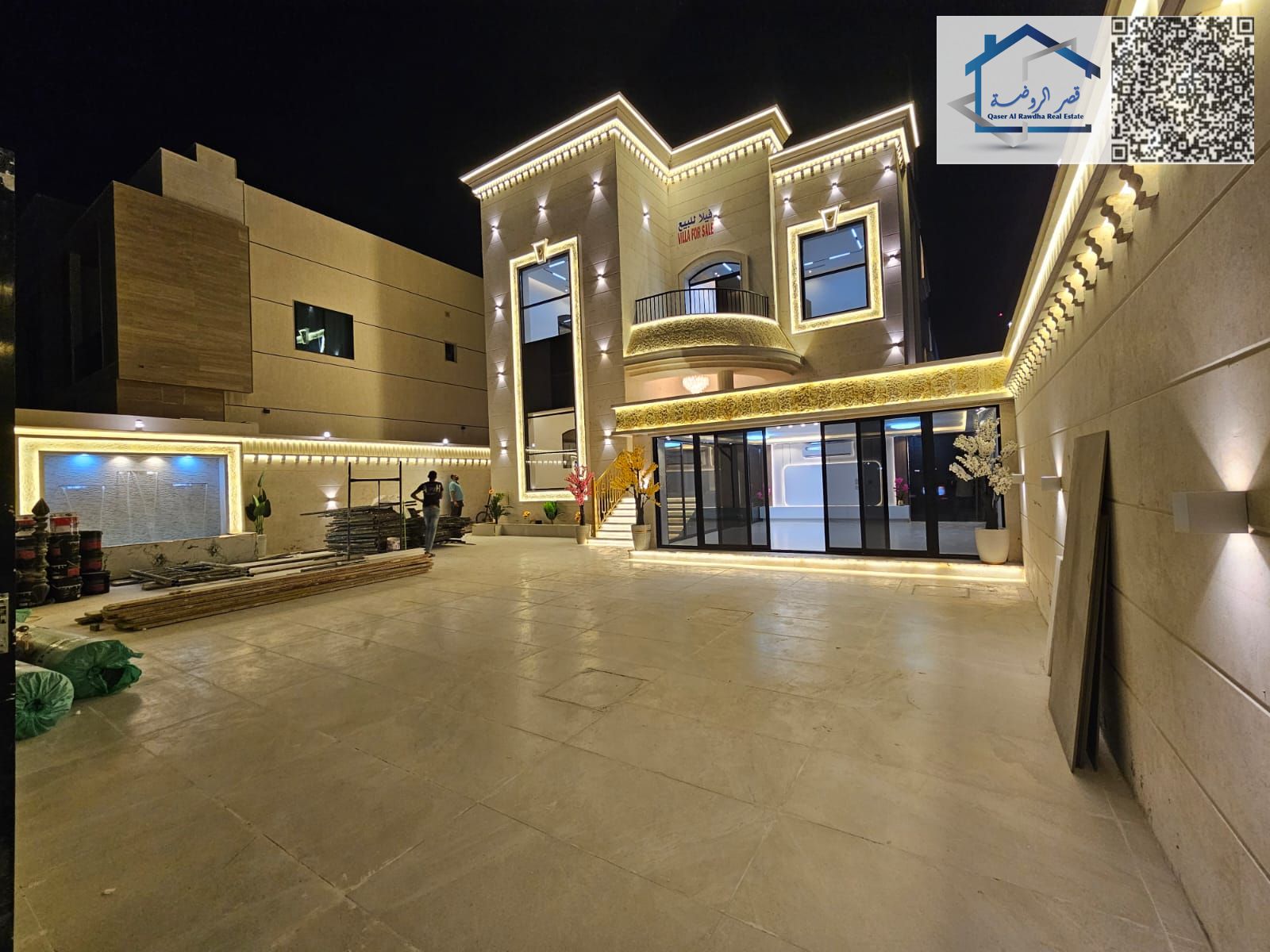 A fully furnished residential and commercial villa, including water, electricity, and air conditioning, located on a main paved road in Al Muwaihat 1