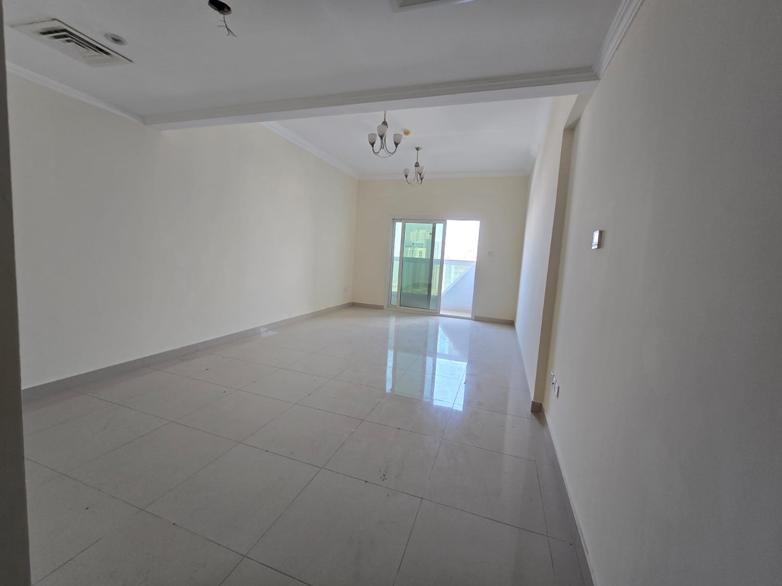3BR hall apartment with balcony and parking in Al Taawun, direct Dubai exit, open sunny views, master room, maid’s room, 3 bathrooms. Rent 65K.