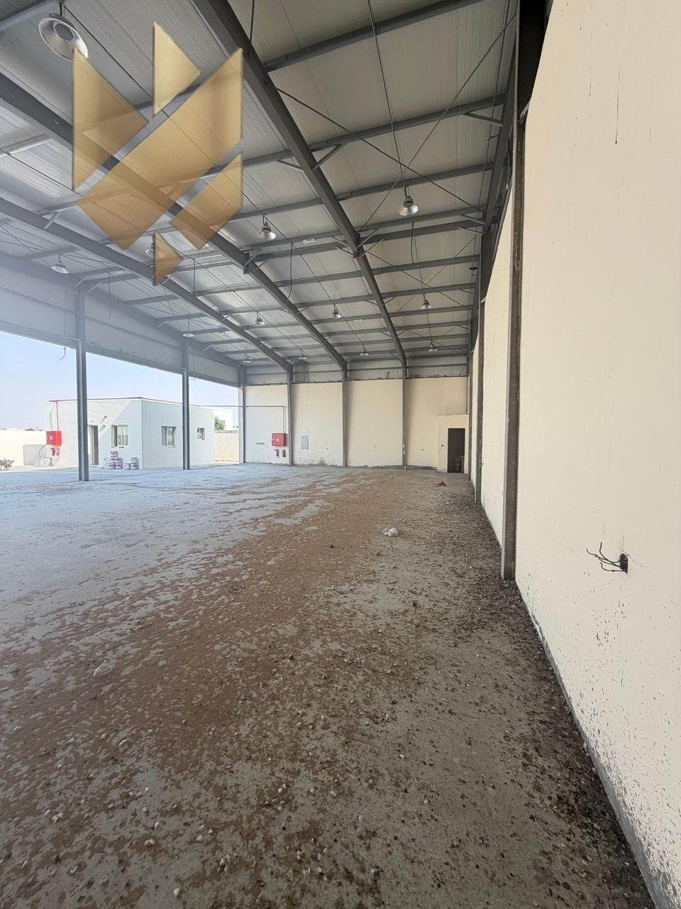 Factory or yard in Sajaa with a large shed, approximately 10,000 sqft, 70 kW power, brand new first use, suitable for all activities.