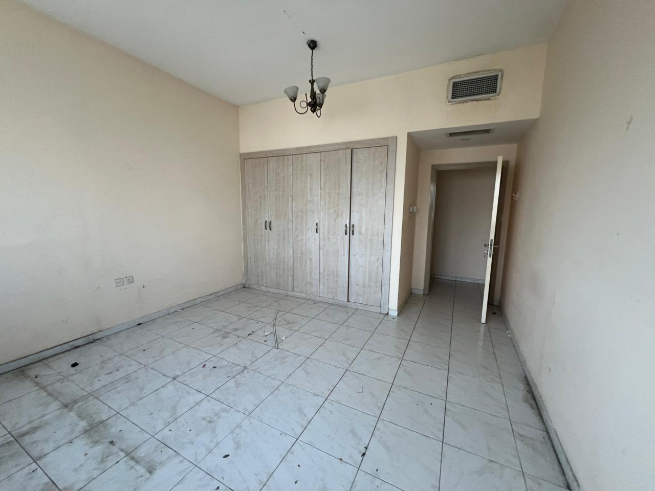 1BR + living with ideal layout | Built-in wardrobes | Central AC | Free maintenance | Open view | Prime location | Dubai exit