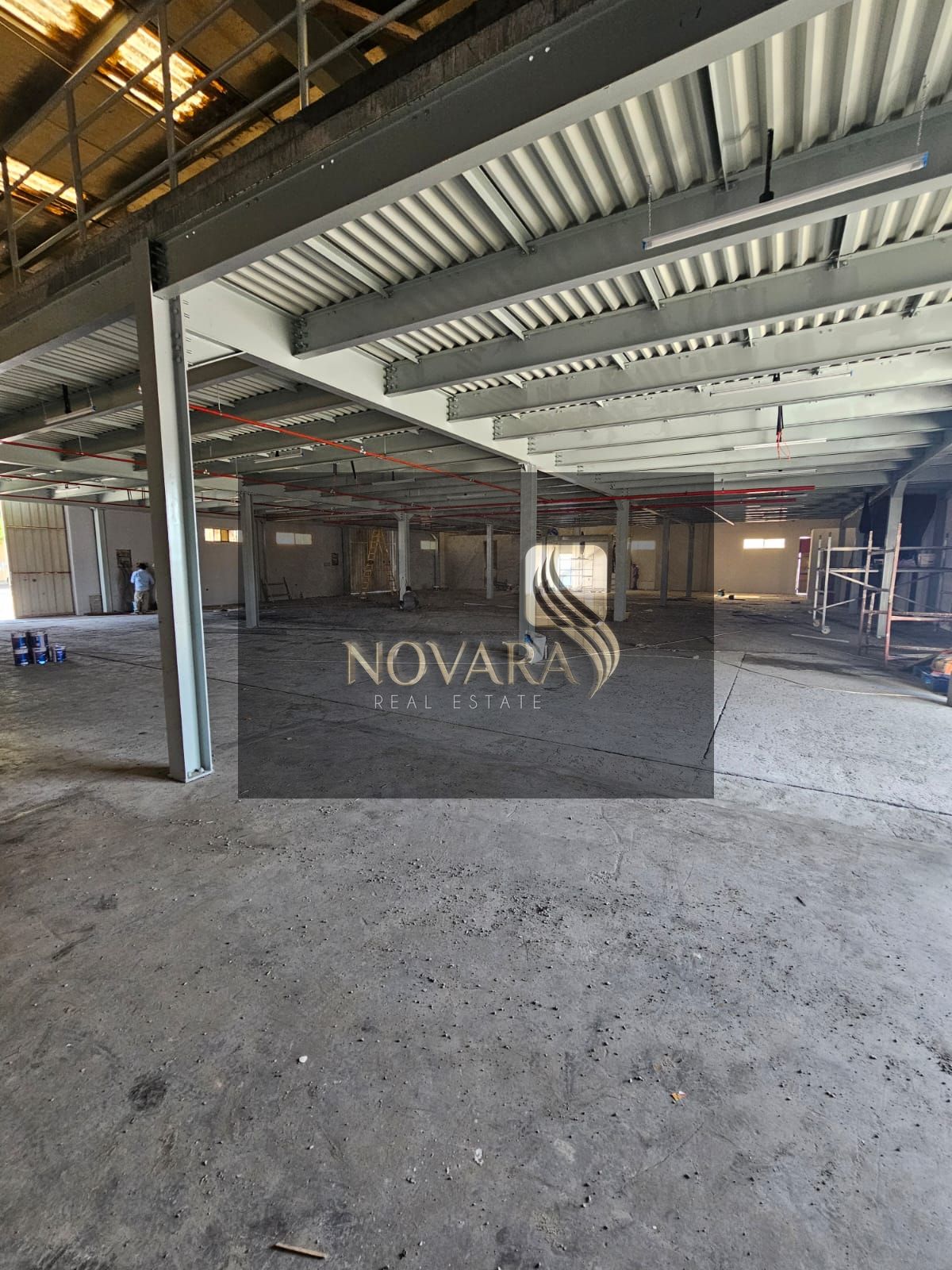 A huge warehouse in Al Jurf Industrial Area 1, Ajman, 15,000 sq ft with mezzanine, office and two bathrooms, main street, price 700,000 dirhams.