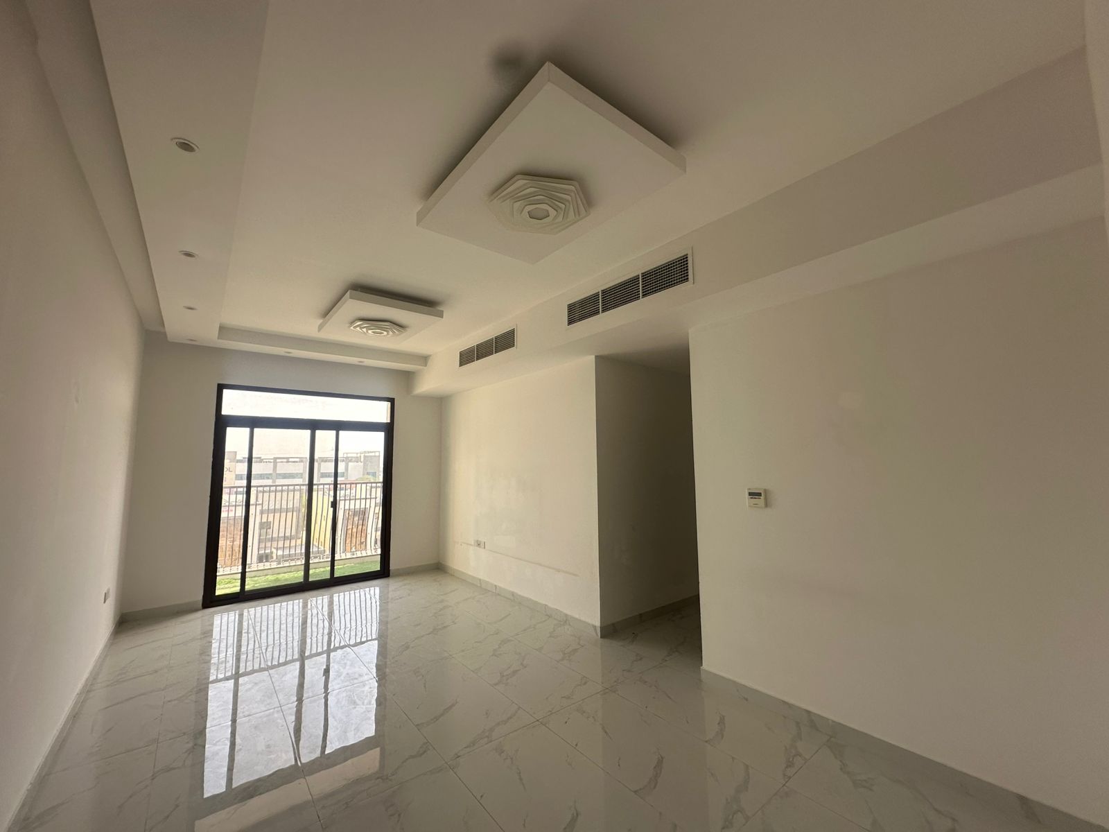 Two bedrooms and a living room in Al Muwaihat 3, large area, three bathrooms with a balcony on the main street next to Ajman Academy