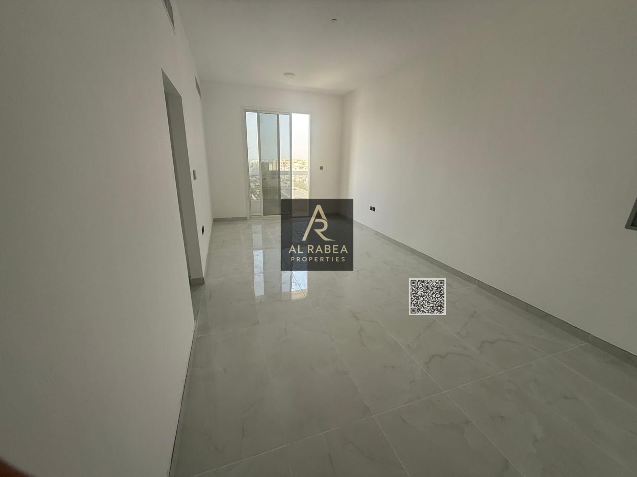 First-tenant apartment for annual rent in Al Jurf 2, Ajman, featuring two bedrooms, a living room, and three bathrooms with spacious areas.
