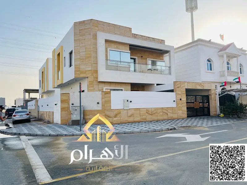 Corner villa for sale in Ajman on two streets, with electricity, water, and air conditioning. A great deal! Excellent location on the main road.