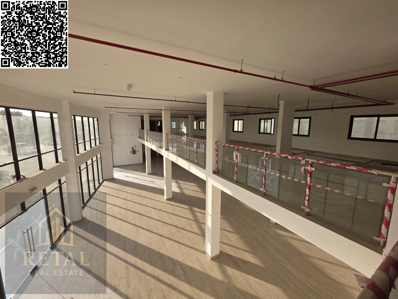 A distinctive showroom for rent on the main street with a large parking area in front.