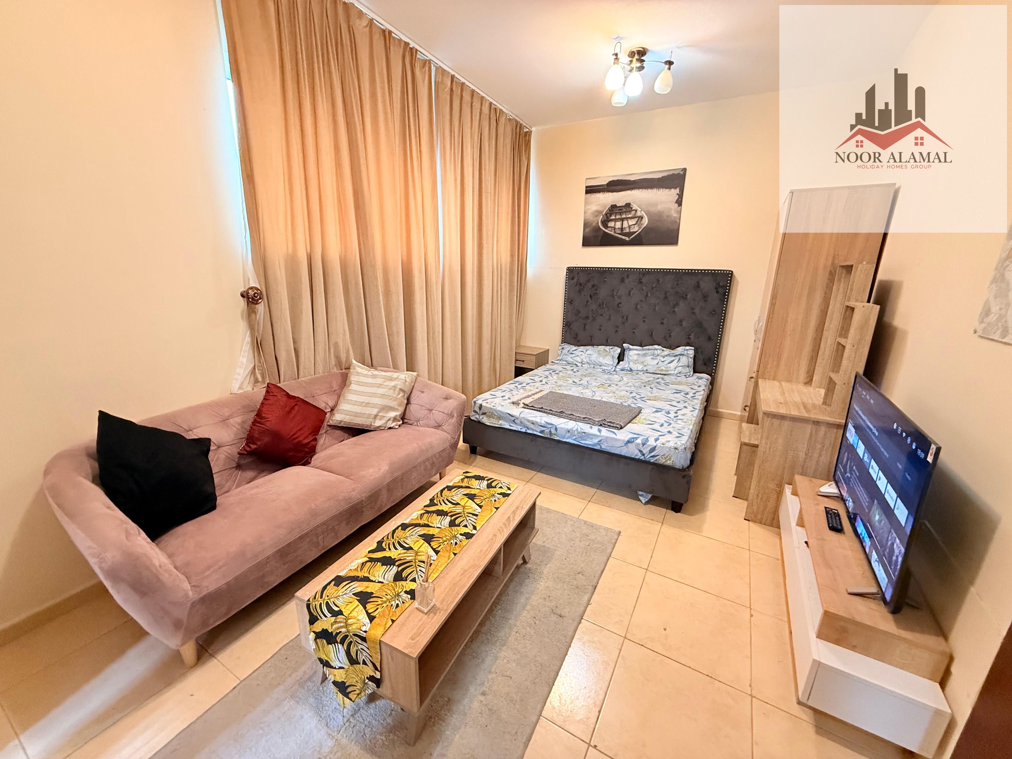 Sharjah Al Khan Furnished studio with second hotel furniture, occupant, large area, room, separate kitchen, bathroom, and large window with sea view.