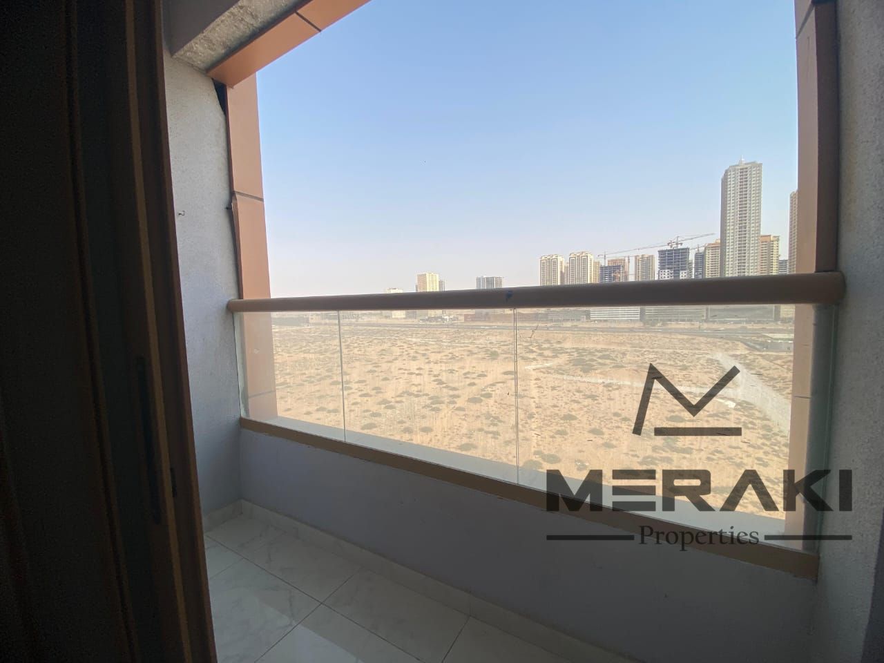 Large space for a room and a living room in Al Ghuroob Towers, 1,060 square feet, ready to move in, directly on Mohammed Bin Zayed Street.
