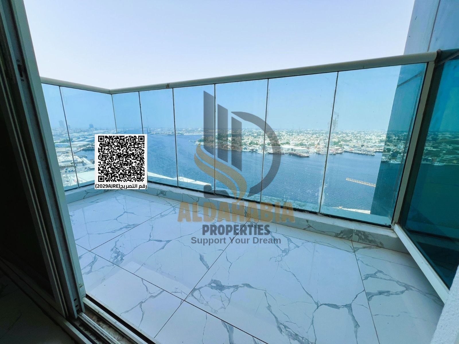 Two-bedroom apartment with a living room and open view of Ajman Creek in Oasis Tower 2 at a special price.