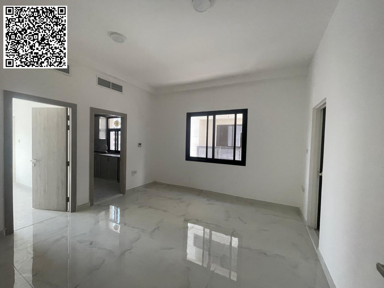 For annual rent in Ajman, a spacious one-bedroom apartment with a living room, two bathrooms, and split air conditioning in all rooms is available in