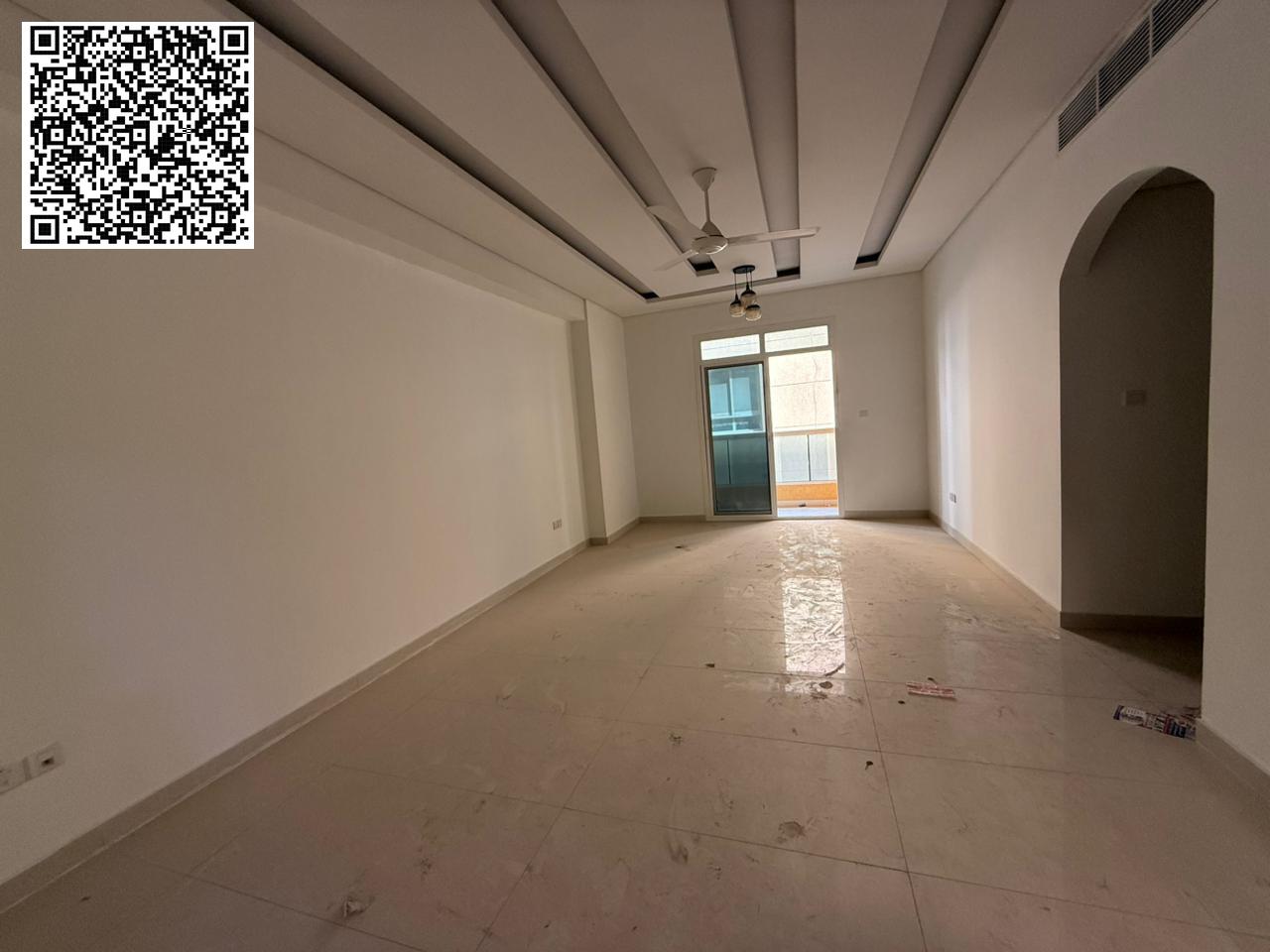 For annual rent in Ajman, a new building offers a two-bedroom apartment with a living room, two bathrooms, a balcony with an open view, spacious layou