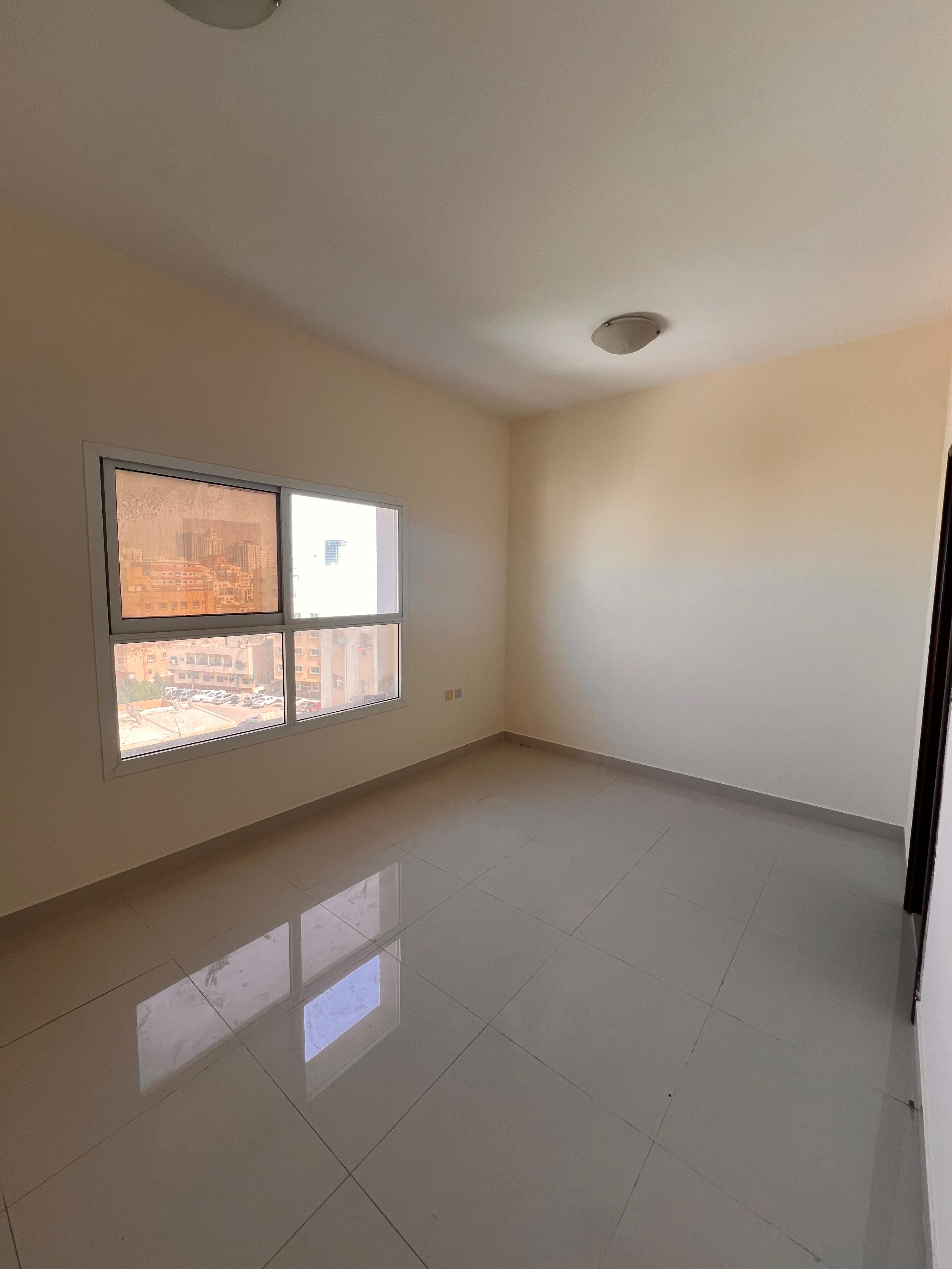 Spacious studio apartment in Al Nuaimiya 3, behind Al Safeer Mall, with a separate kitchen and central air conditioning.