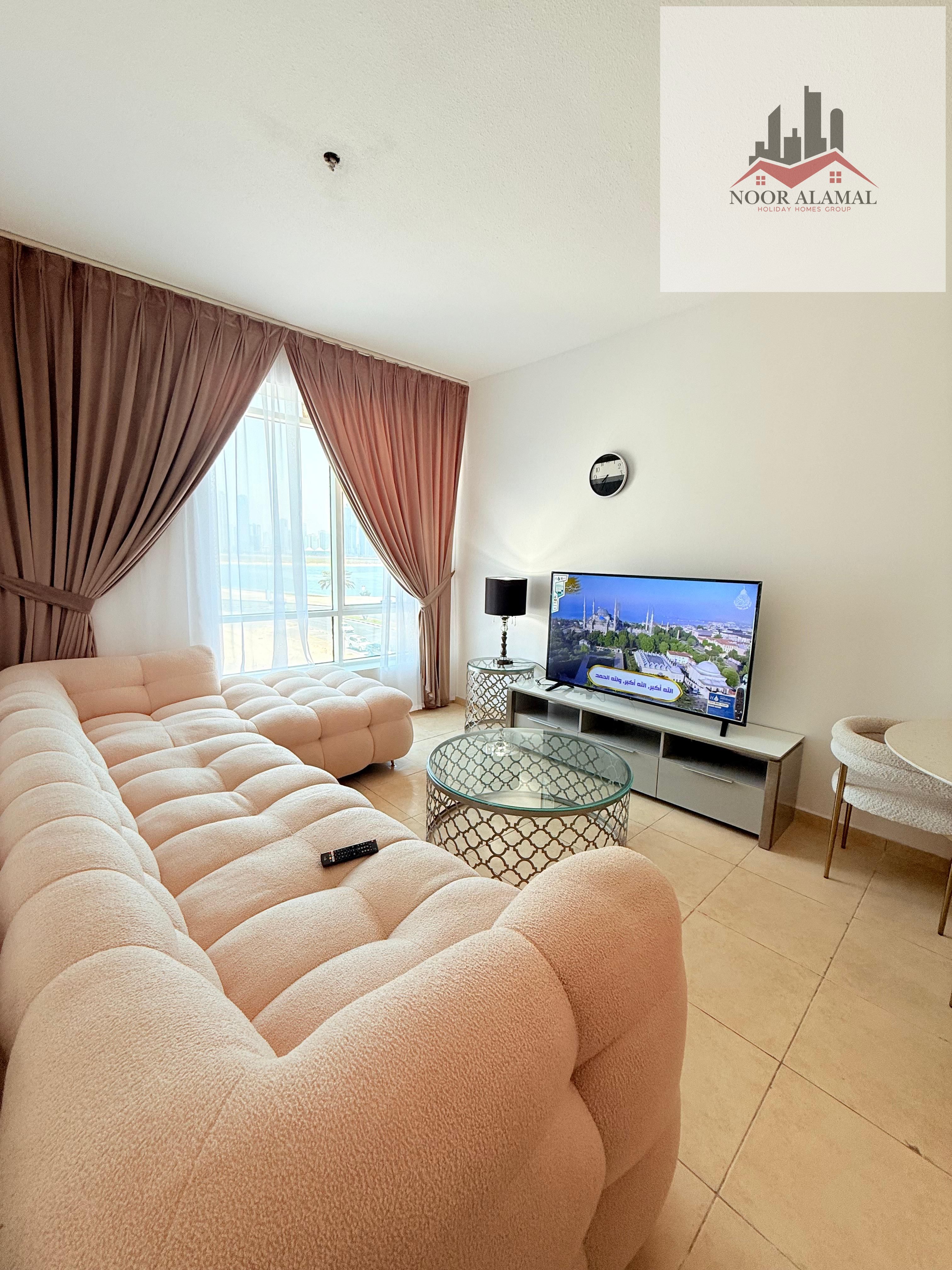 Sharjah, Al Khan, furnished studio apartment with hotel-style furnishings, first occupancy, spacious room, separate kitchen, bathroom, large window,