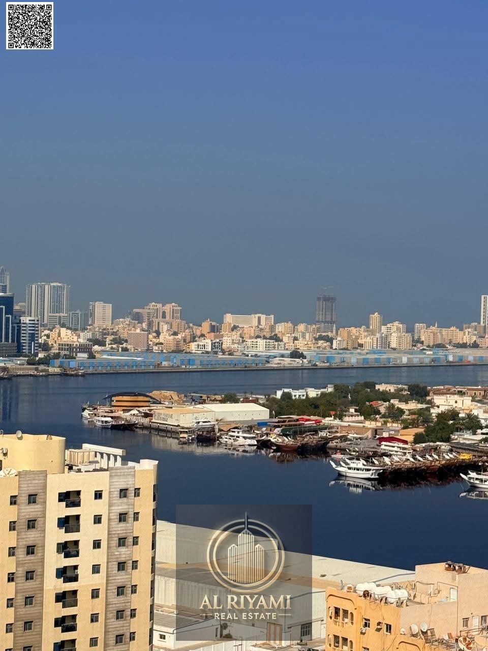 A spacious furnished one-bedroom apartment with a balcony overlooking the creek in Al Muhairi Towers, Al Rashidiya.