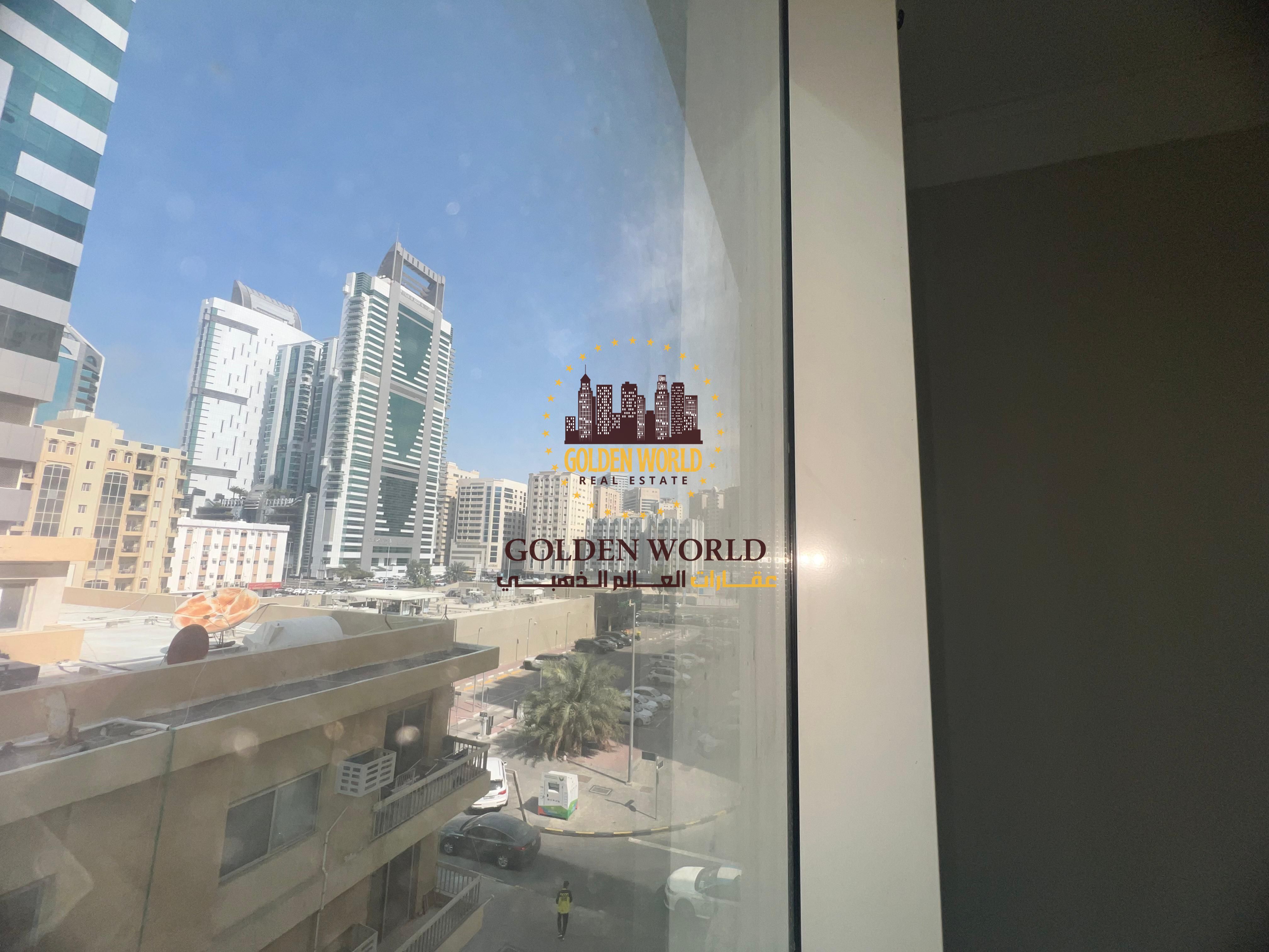 Two-bedroom apartment with living area in Al Majaz 1, bright side view, two bathrooms, practical layout for families or individuals