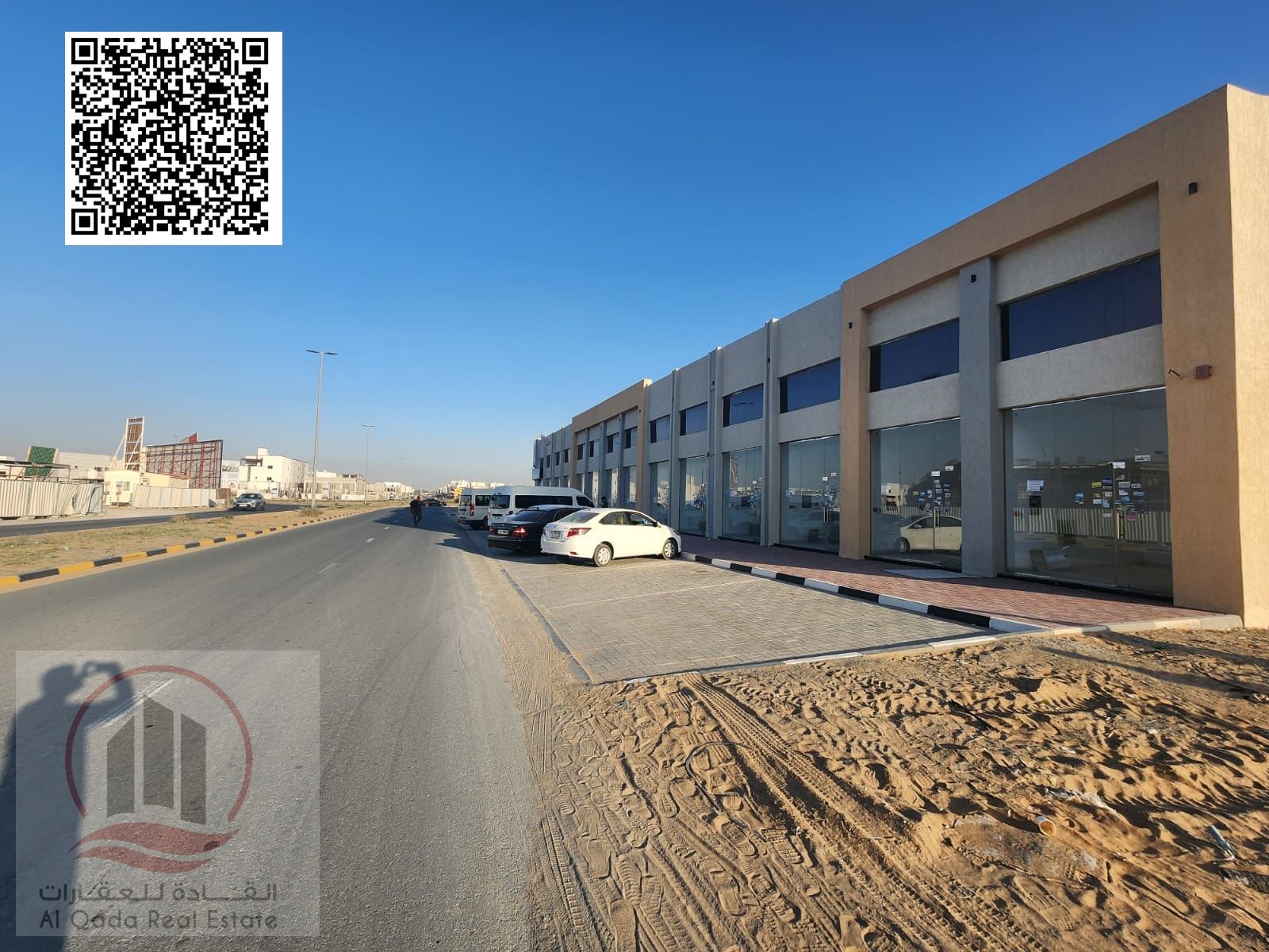 Al Amrah, Ajman – Commercial building for sale consisting of 4 shops and a mezzanine, located on Al Amrah roundabout directly opposite Azha Complex