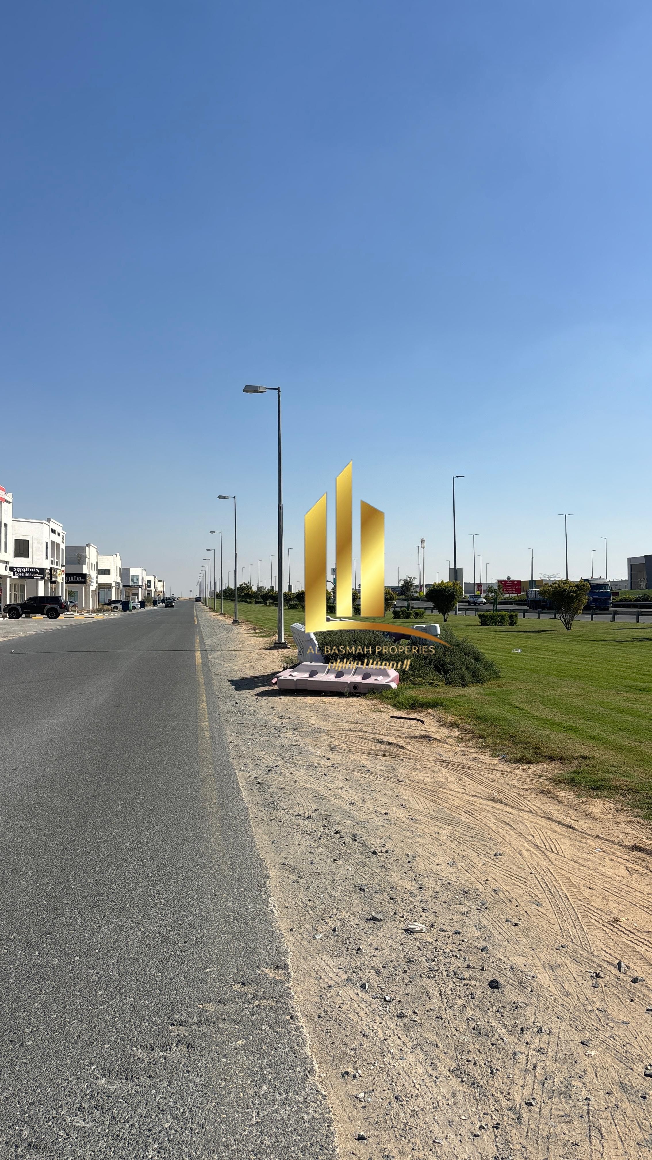 Corner commercial land for sale in Al-Hawshi, Al-Badi'a suburb, Sharjah.