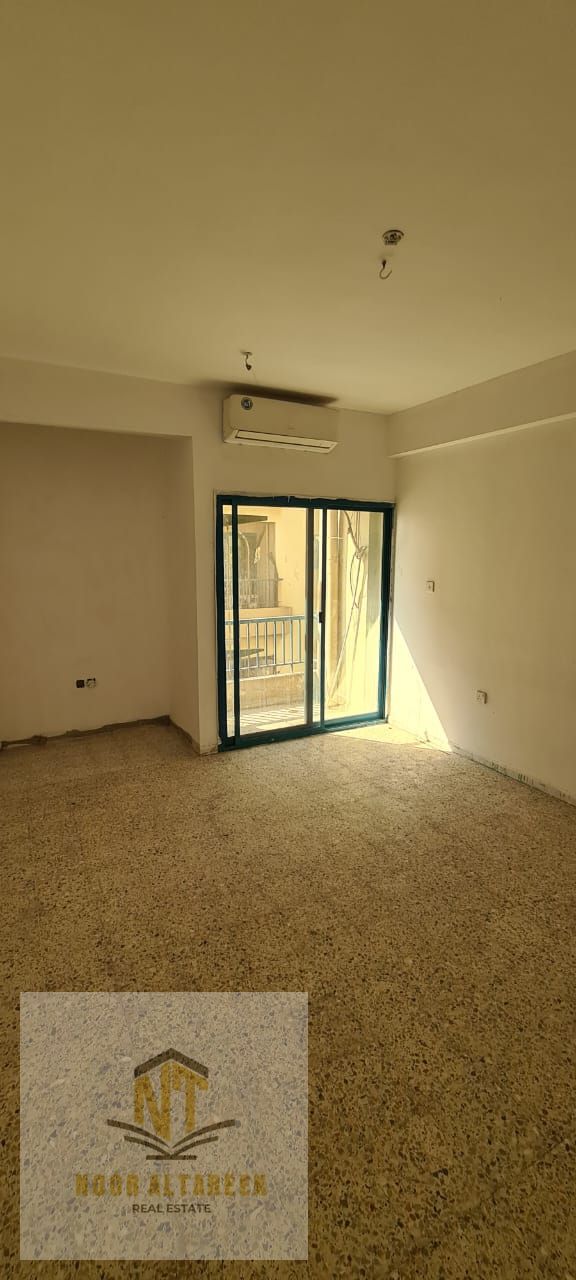 An annual apartment for rent offered by Noor Al Tareeq Real Estate, featuring a beautiful sea view and a lively, service-oriented location close to a