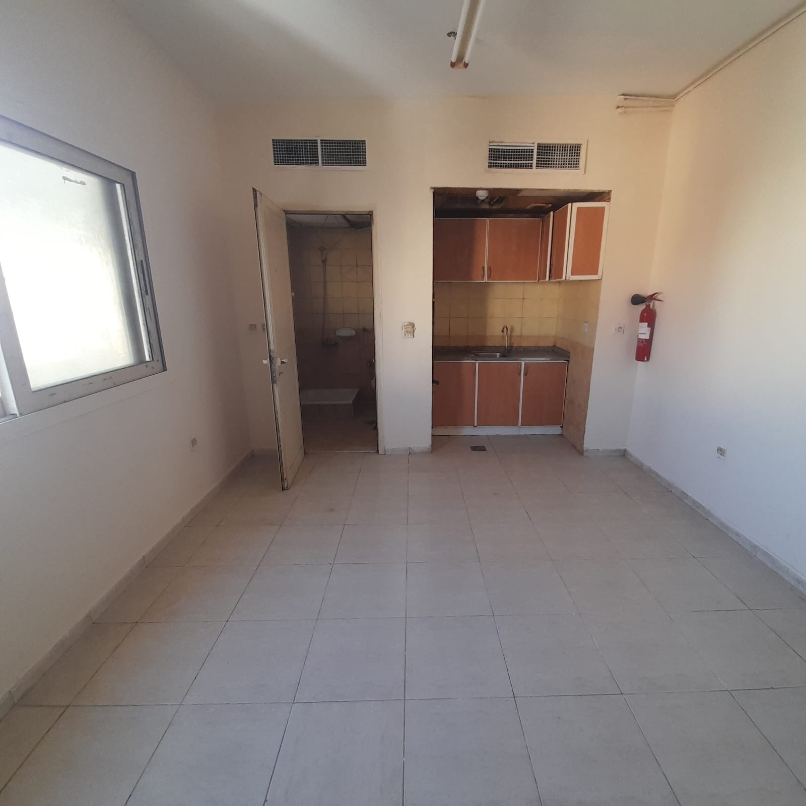 Studio in Al Boutina for families only, with a spacious layout. Annual rent AED 16,000, payable in 4 installments only. Security deposit AED 1,000 cas