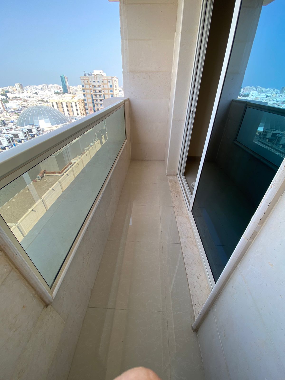 2BR apartment in Budaniq opposite Mega Mall, 2 baths, balcony, central AC, parking, maintenance by landlord, AED 45,000.