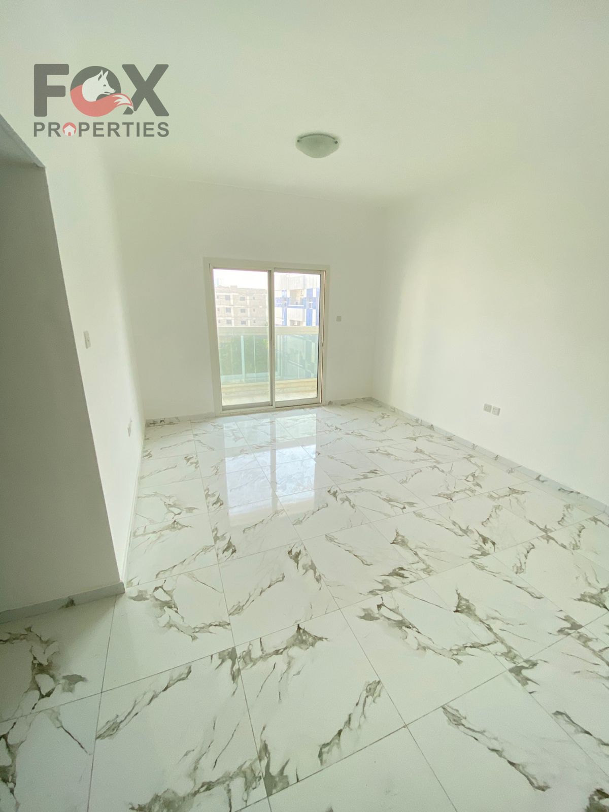For annual rent in Ajman, Al Rashidiya 2 area, opposite Ladies Park: two bedrooms, living room, two bathrooms, balcony, central air conditioning, 1300