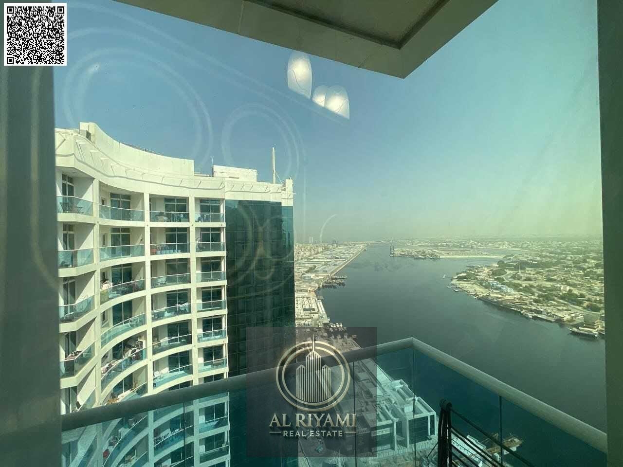 Family accommodation, two-bedroom apartment with a living room, monthly rent in Al Waha Towers, open view of the creek