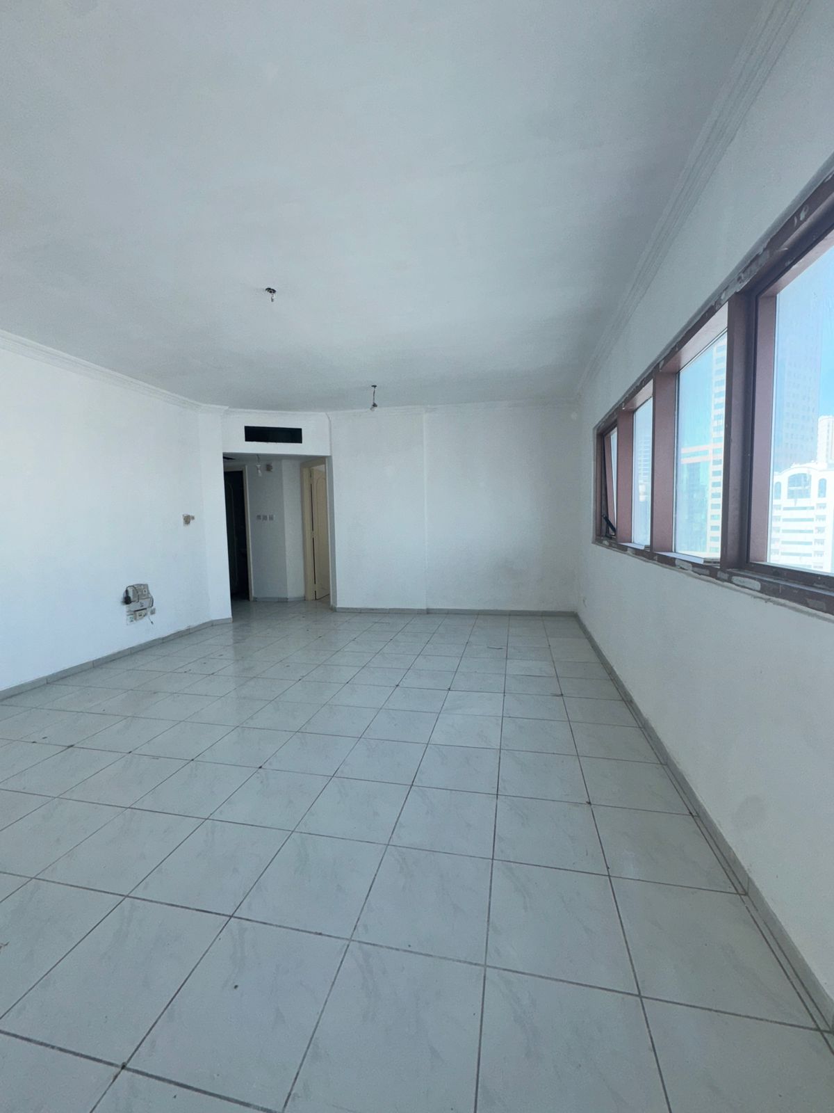 2BR apartment in Al Majaz 2, AC & electricity covered by landlord, 2 bathrooms, full-service tower, employees allowed, easy access to Dubai.