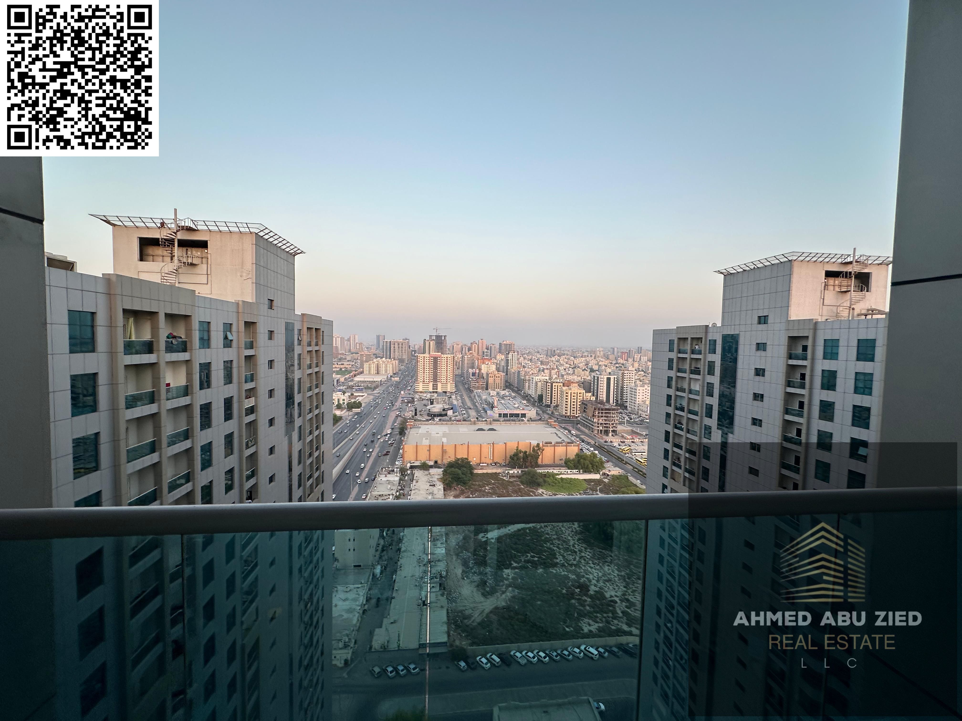 **Elegant 2BR hall in Ajman with open city-view balcony, modern finishes, stylish design, prime location near all services, and spacious layouts. **