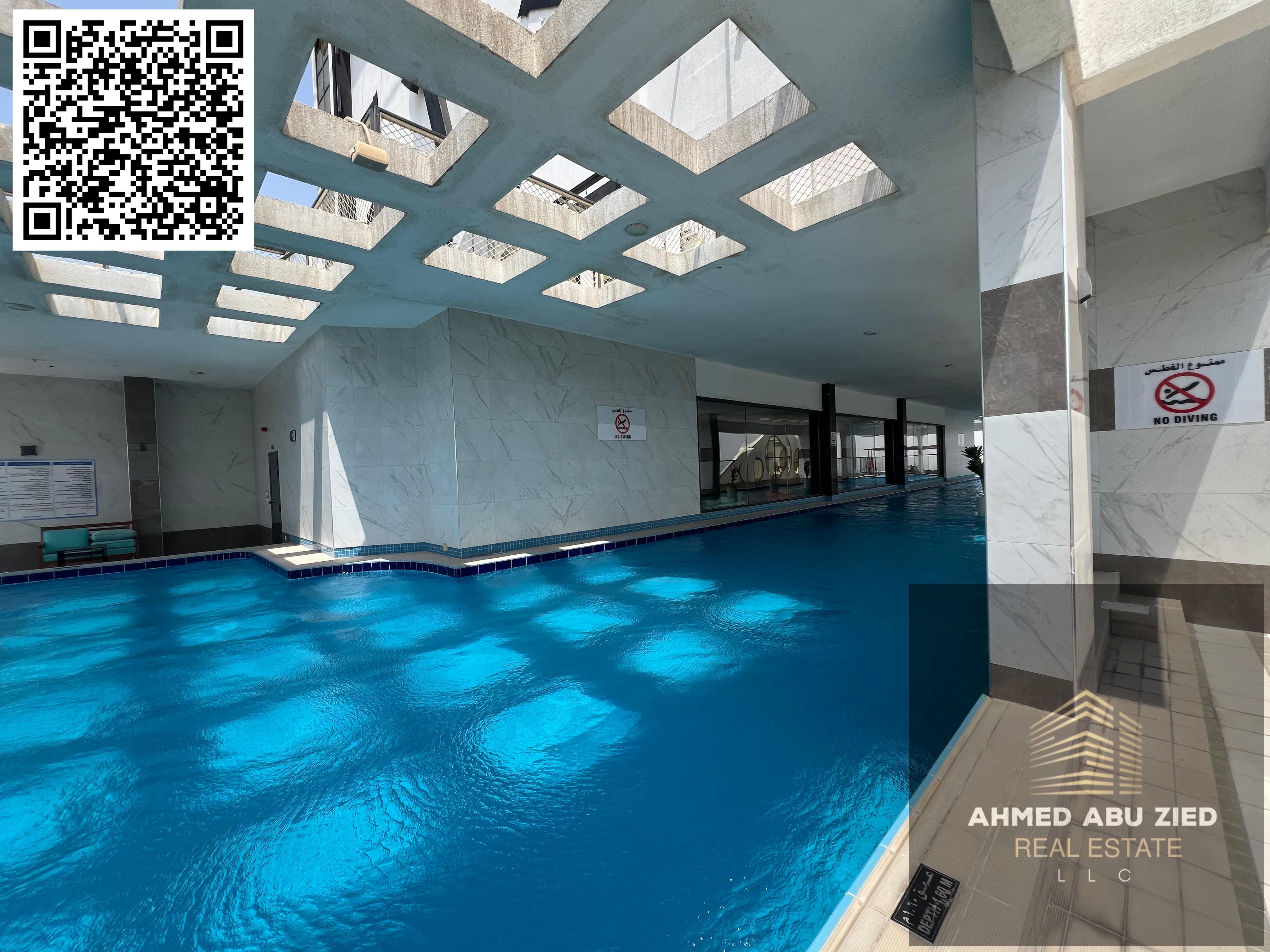Upscale two-bedroom apartment with a living room, three bathrooms, central air conditioning, a balcony with an open view, built-in wardrobes, a gym, a