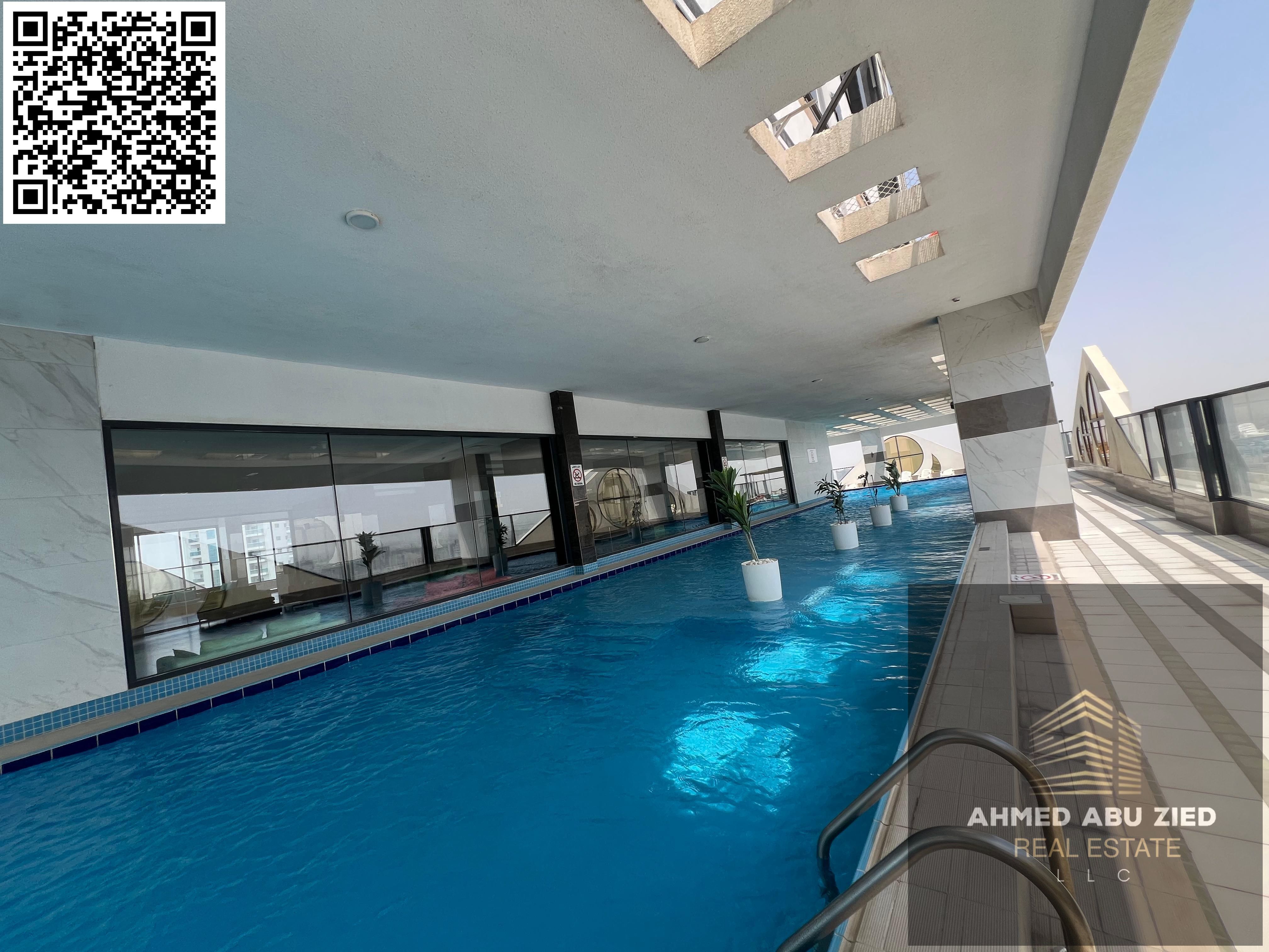 The finest two-bedroom apartments for annual rent in Ajman Al Rashidiya, featuring a gym, swimming pool, and aqua park. High-end finishing, distinguis